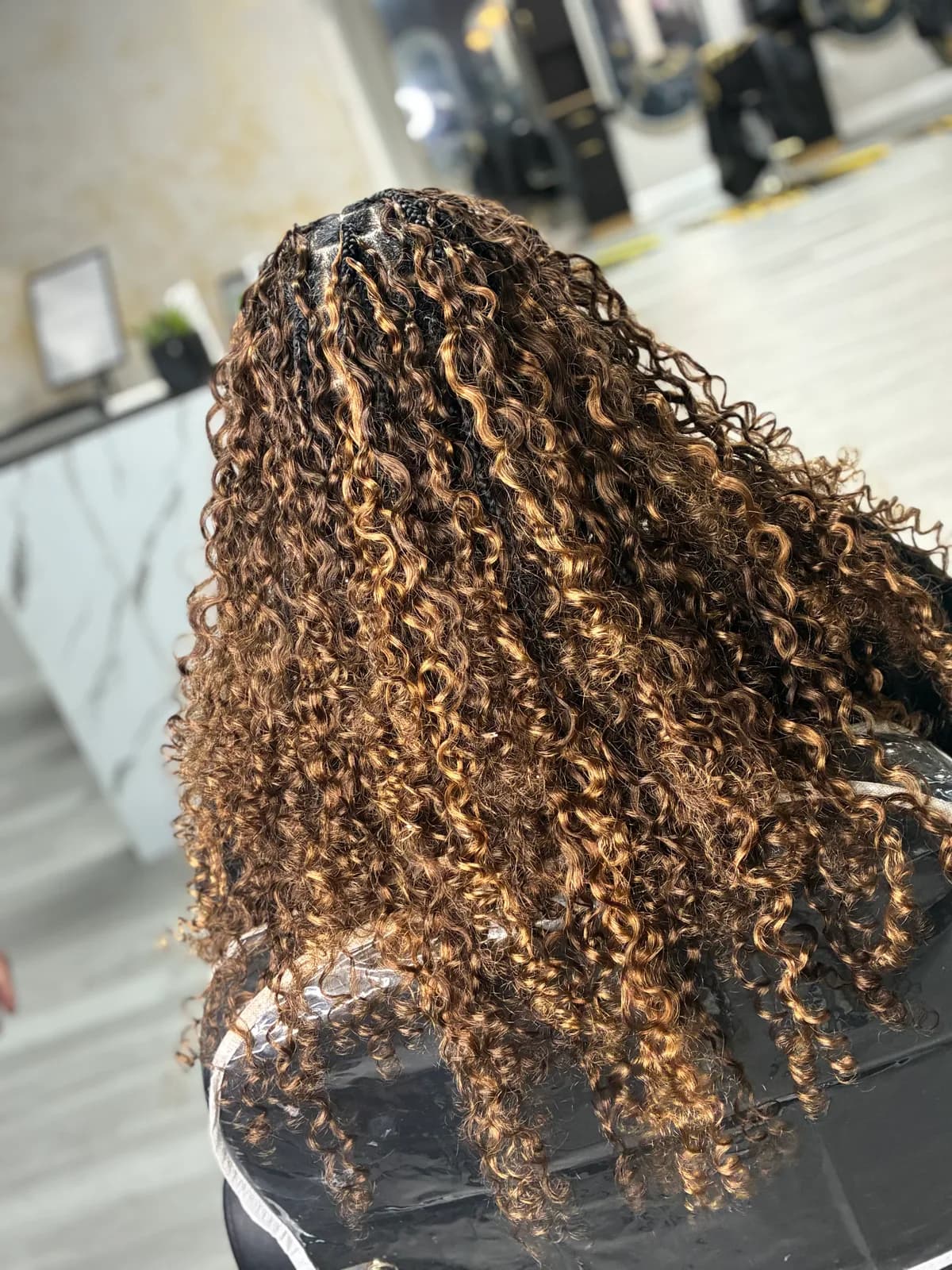 Brown boho curls with warm honey highlights