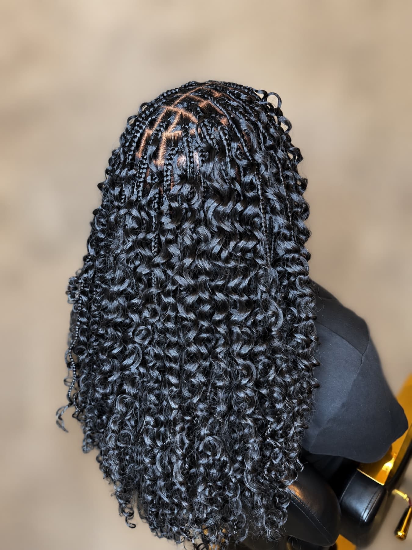 Glossy black boho curls with neat braided roots